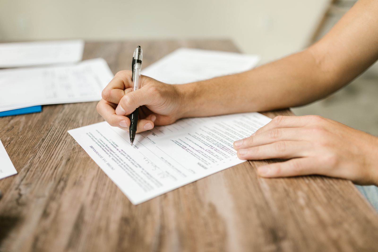 Consumer completing a form at a table